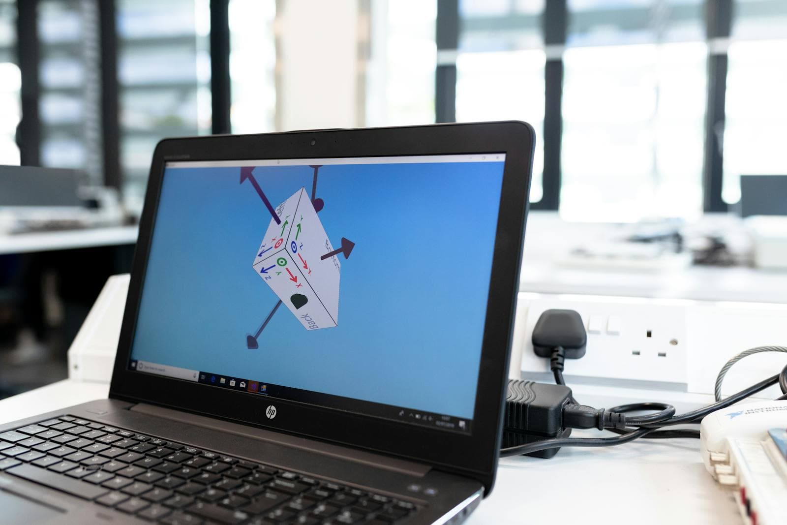 A 3D CAD model being designed on screen
