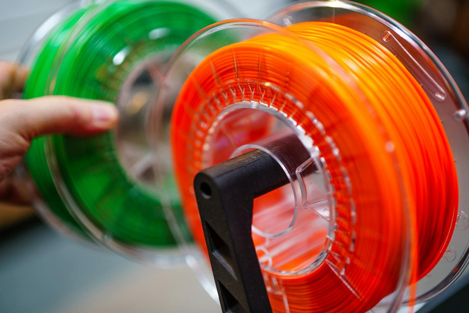 Colourful 3D printer filament spools on a rack